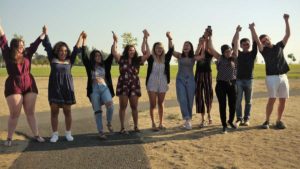 Fellows grad holding hands (16x9))